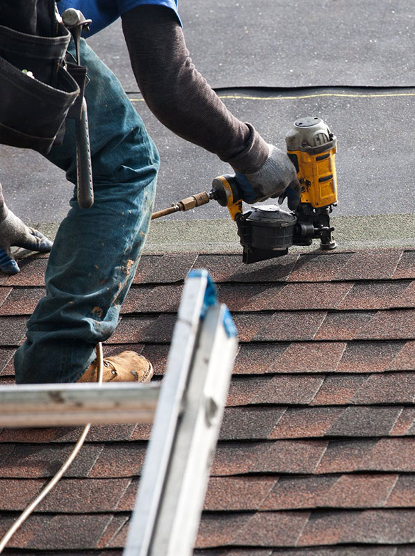 worker fixing roof